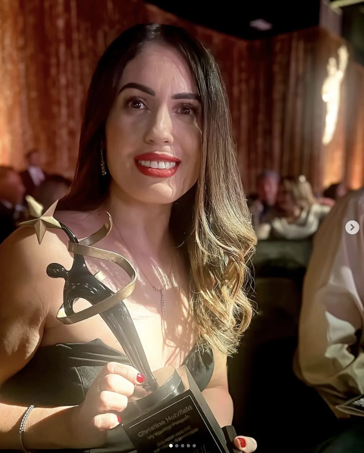 Christine Lopez, founder of My Healthy Penguin, holding her Spirit Awards Top Female Entrepreneur of the Year trophy